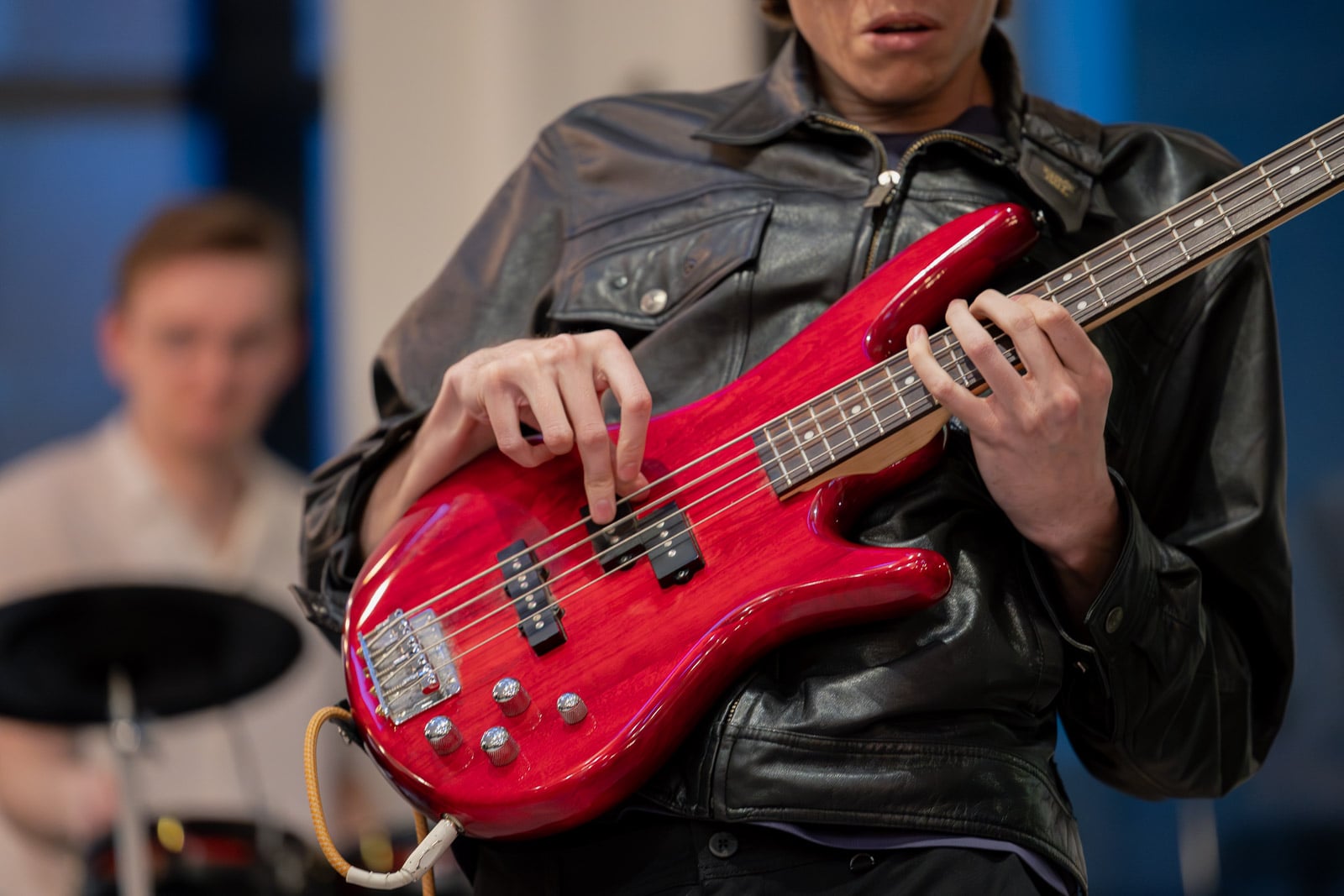 Close up of an adult bass student fretting notes during a lesson in Downtown Boston