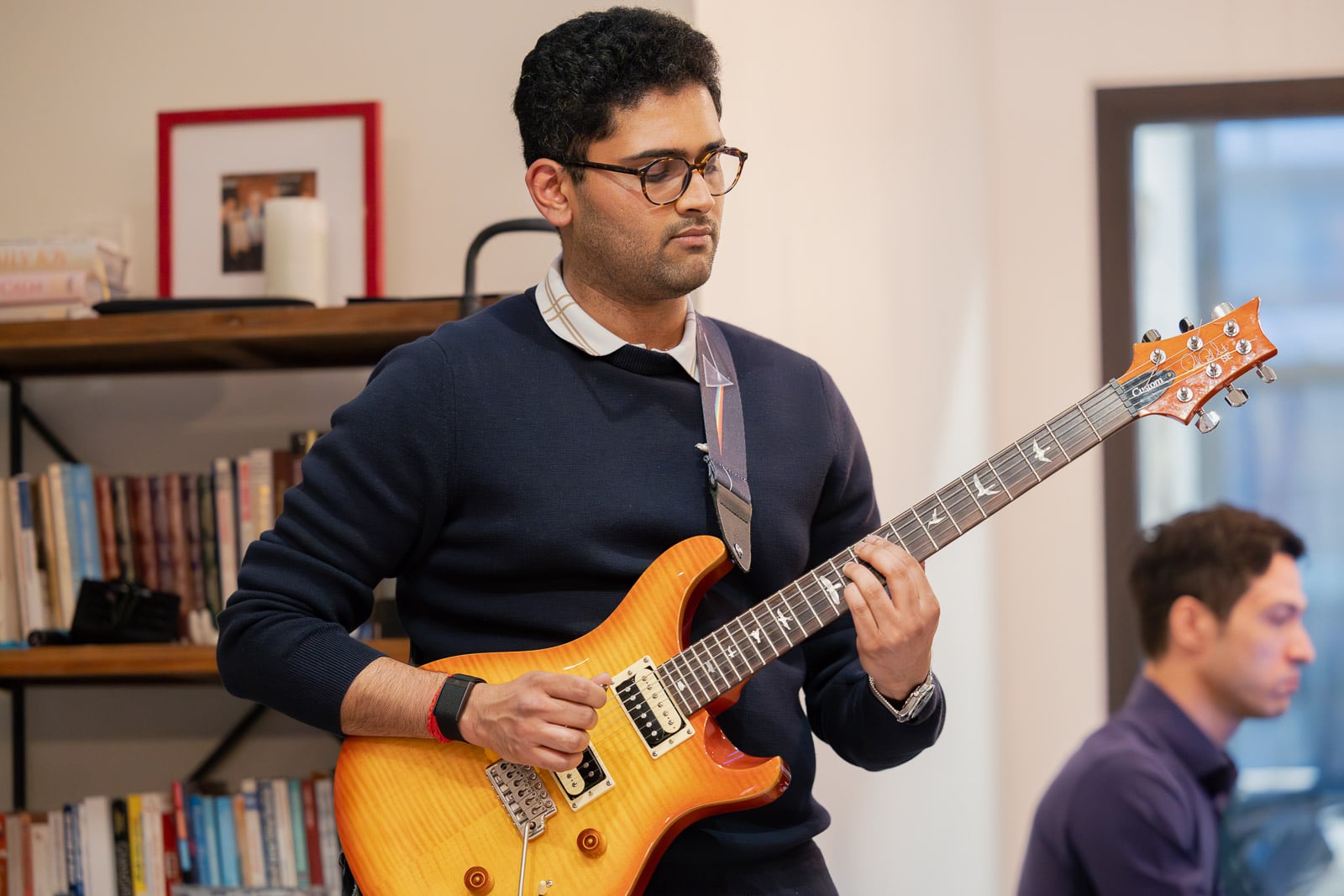 Adult guitar student playing electric guitar during a lesson at Musicians Playground