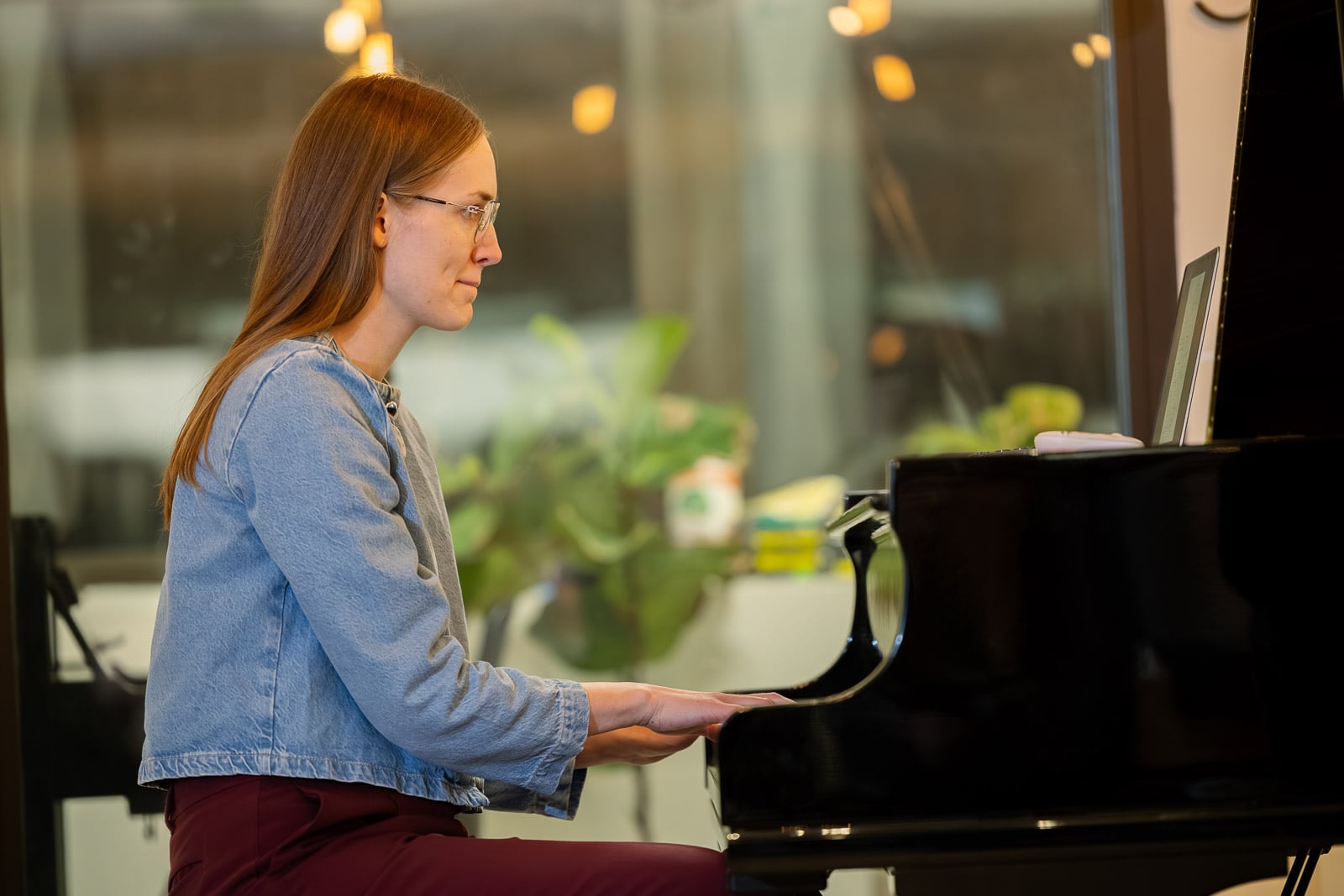 Adult piano student at the keys in the bright studio at Musicians Playground